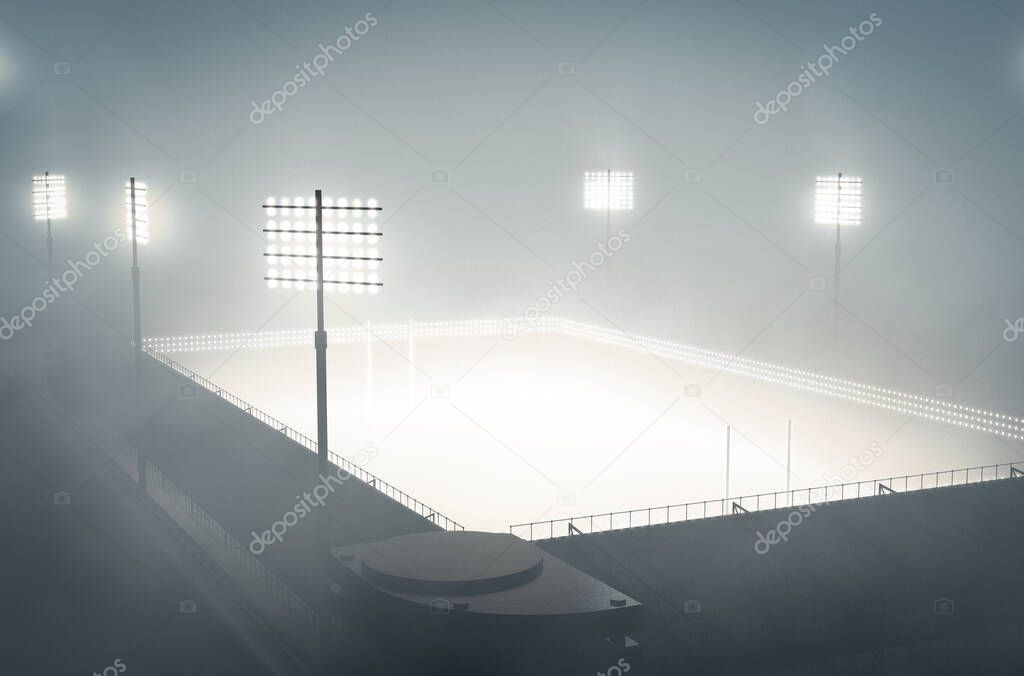 A rugby stadium illuminated by flood lights in the night covered by a thick misty atmosphere - 3D render