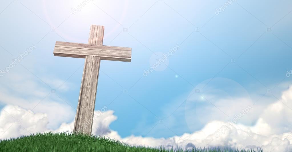 Crucifix On A Grassy Hill And Blue Sky