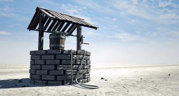 Wishing Well With Wooden Bucket On A Barren Landscape — Stock Photo, Image