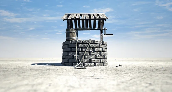 Wensen goed met houten emmer op een dorre landschap — Stockfoto