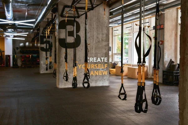 Fitness equipment. Trx straps inside of a gym, functional training and sport accessories