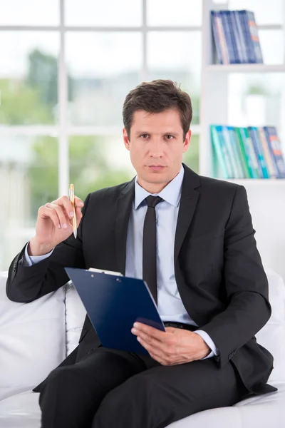 Portrait of male psychologist in his office