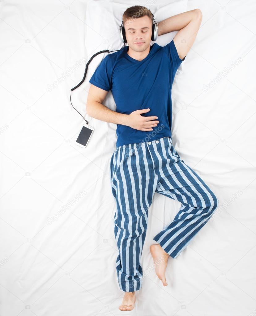 Man listening to music before sleeping — Stock Photo © dima_sidelnikov