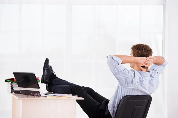 Back side photo of relaxed business man on headchair