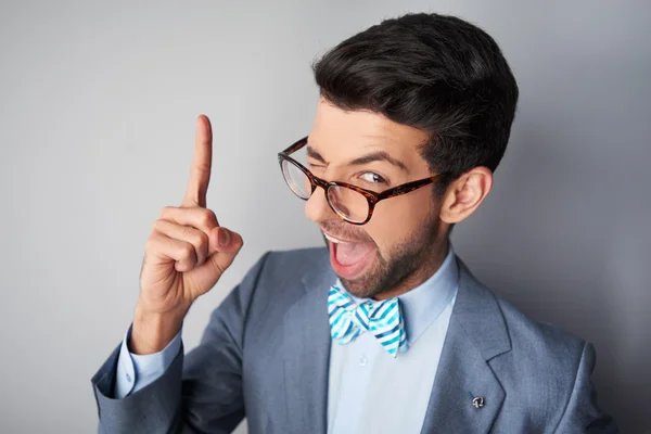 Funny young man with glasses and jacke winking