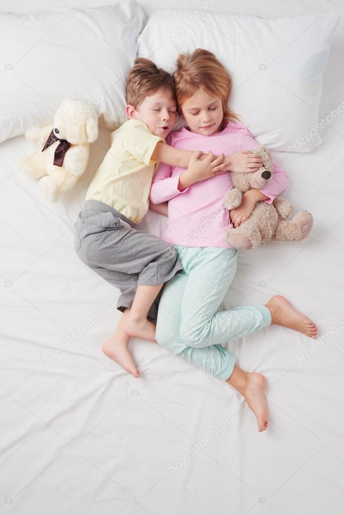 Старшая сестра и братик. Мелкие девчушки в кровати. Девочка спит с мальчиком. Спящих мальчиков и девочек. Спят вместе в обнимку.