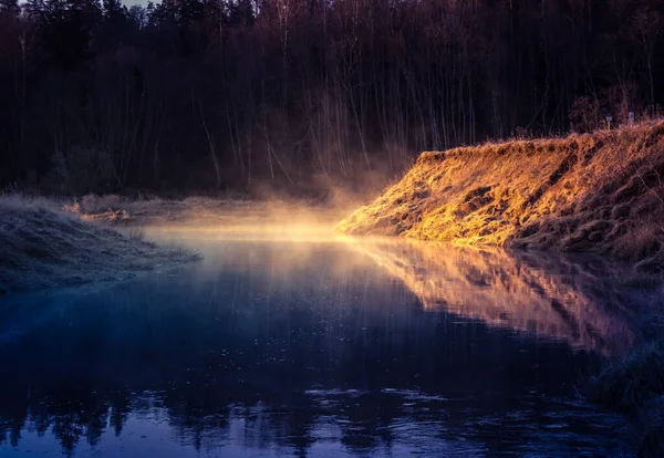 A beautuful landscape of a river in early spring. Springtime scenery of sunrise over the river valley in Northern Europe. Misty morning at the river side.