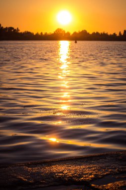Riga, Letonya 'da nehrin üzerinde güzel bir günbatımı. Nehirde bir yaz akşamı.