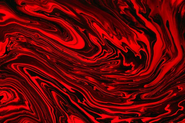 Fluid art texture. Abstract background with swirling paint effect. Liquid acrylic artwork with colorful mixed paints. Can be used for background or poster. Red, black and orange overflowing colors.