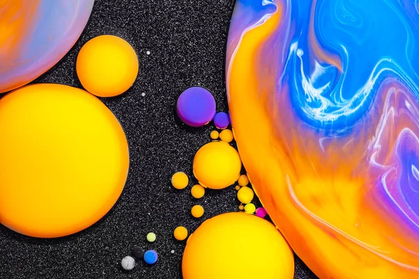 Fluid art texture. Abstract backdrop with mixing paint effect. Liquid acrylic artwork that flowing bubbles. Mixed paints for posters or wallpapers. Black and vibrant overflowing colors.