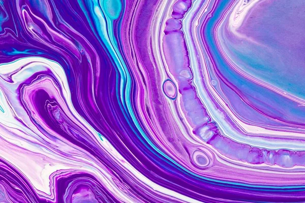 Fluid art texture. Backdrop with abstract swirling paint effect. Liquid acrylic artwork with flows and splashes. Mixed paints for posters or wallpapers. Purple, blue and white overflowing colors.