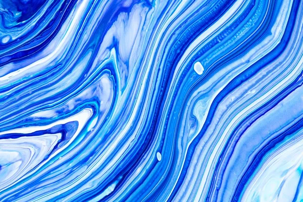 Fluid art texture. Abstract backdrop with mixing paint effect. Liquid acrylic picture with flows and splashes. Mixed paints for posters or wallpapers. Blue, navy blue and white overflowing colors.