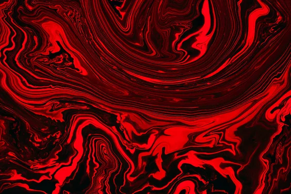 Fluid art texture. Background with abstract iridescent paint effect. Liquid acrylic artwork with flows and splashes. Mixed paints for background or poster. Red, black and orange overflowing colors.