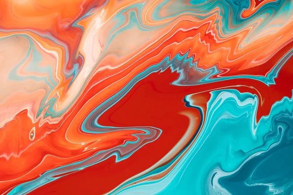 Colored inks mixed on a liquid artistic texture. A background with colorful waves and streams of paint, fluent and smooth shapes and swirls. Fluid art backdrop that was made by mixing dyes.