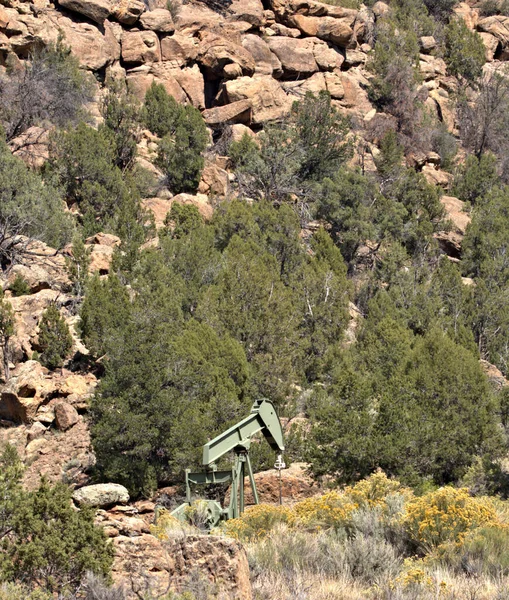 Oil pumping rig located in the desert mountains of Arizona