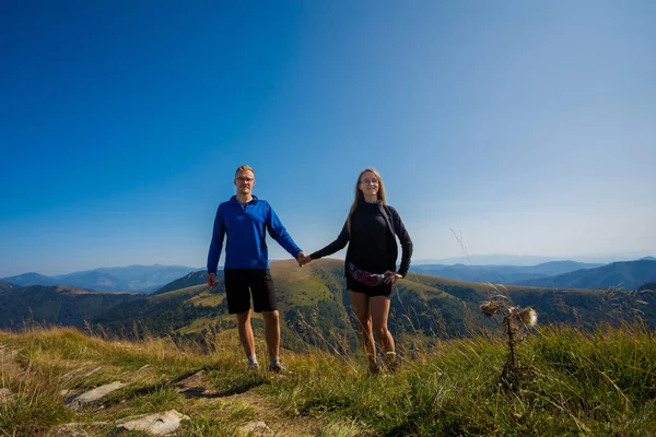 Happy couple trekking in autumn woods, photo taken in slovakian Velka Fatra mountains, path through Borisov and Ploska.
