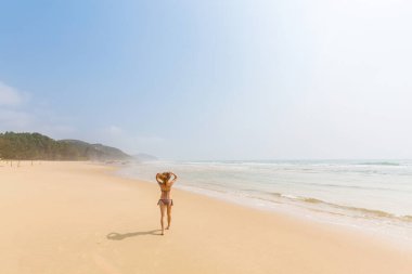 Young woman on Quan Lan beach - Bai Bien - island, Bai Tu Long Bay, Vietnam. Seaside scenery photo taken in south east Asia, Ha Long area.