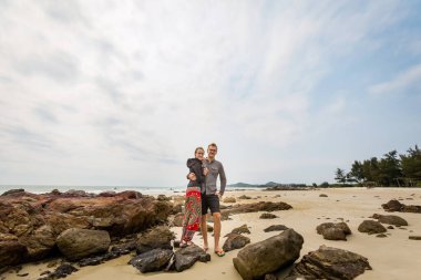 Happy tourist couple on Son Hao beach, Quan Lan island, Bai Tu Long Bay, Vietnam. Seaside scenery photo taken in south east Asia, Ha Long area.