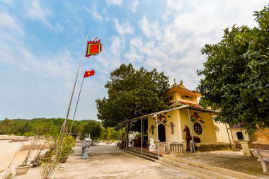 Beautiful landscape of Den Mau - Den Cau Cua Dong pagoda in Quan Lan island, Bai Tu Long Bay, Vietnam. Seaside scenery photo taken in south east Asia, Ha Long area.