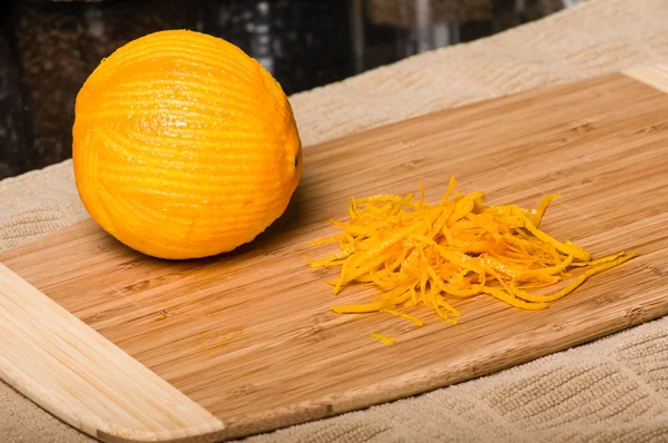 Orange being cut to produce zest — Stock Photo, Image