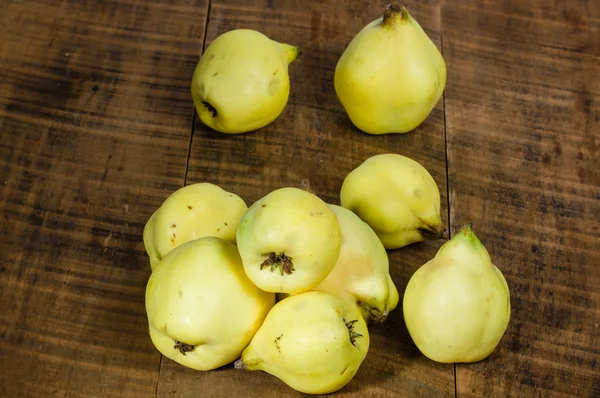 Yellow quince on wooden table — Stock Photo, Image