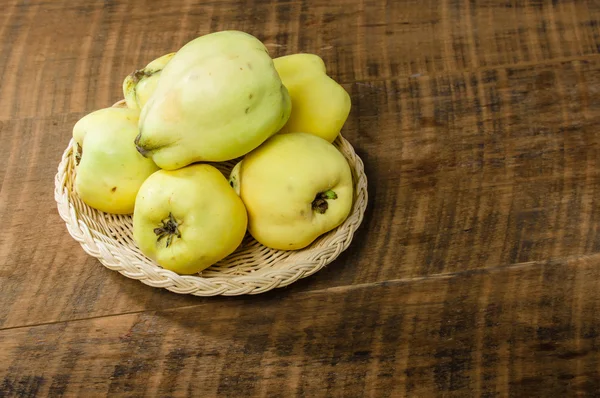 Yellow quince on wooden table — Stock Photo, Image
