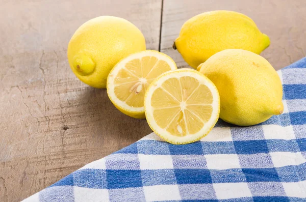 Yellow lemons on wooden table — Stock Photo, Image