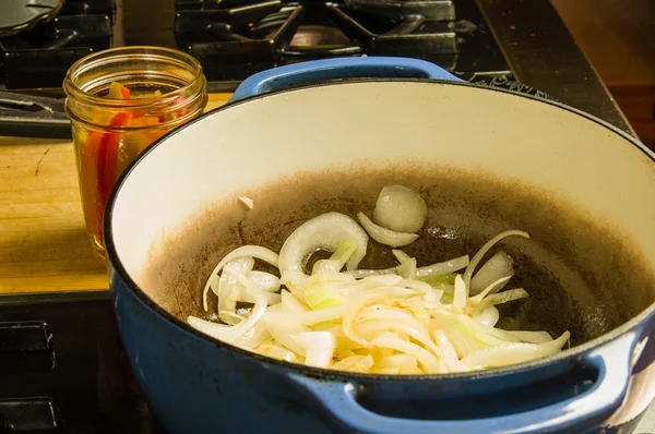 Onion slices being cooked on the stove — Stock Photo, Image