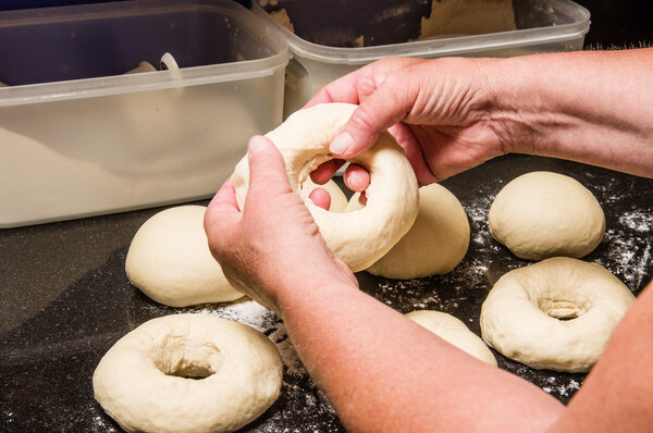 Baker making bagels from dough
