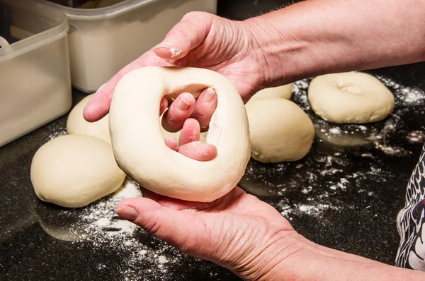 Bäcker stellt frische Bagels her — Stockfoto