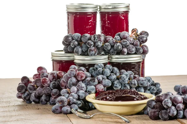 Bowl of grape jelly with jars isolated — Stock Photo, Image