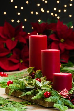 Yeşiller ve holly kırmızı mum centerpiece