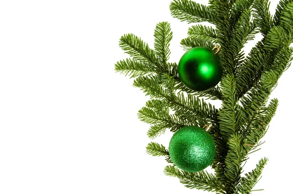 Noble fir bough with green ornaments — Stock Photo, Image