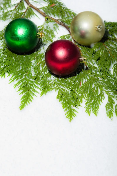 Vertical of Christmas balls on snow — Stock Photo, Image
