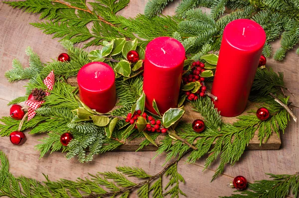 Three red candles in a Christmas arrangement — Stock Photo, Image