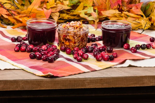Cranberry sauce with cranberries on wooden table — Stock Photo, Image