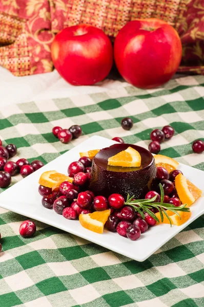 Cranberry sauce on plate with red apples — Stock Photo, Image