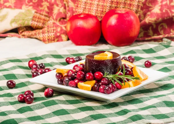 Cranberry sauce on plate with red apples — Stock Photo, Image