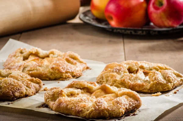 Parchment paper with apple tarts — Stock Photo, Image