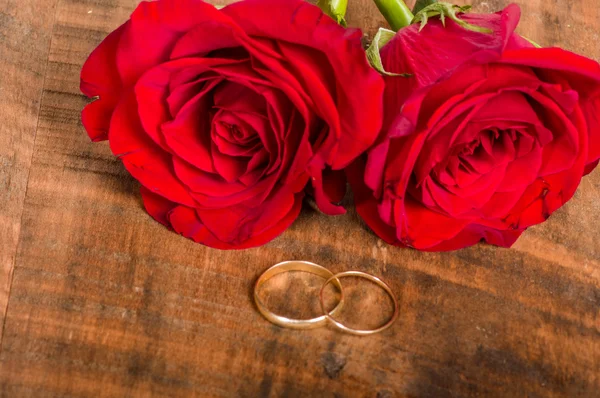 Gold bands on wooden table — Stock Photo, Image