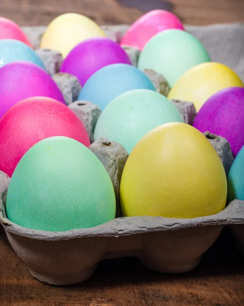 Egg carton of colorful dyed Easter eggs — Stock Photo, Image