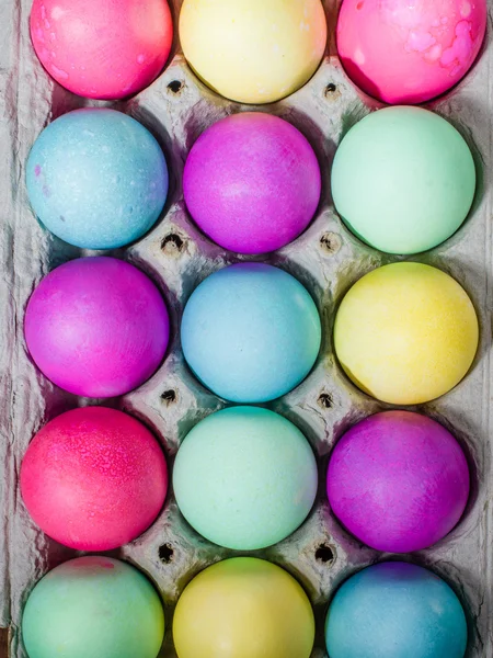 Egg carton of colorful dyed Easter eggs — Stock Photo, Image