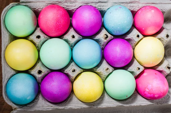 Egg carton of colorful dyed Easter eggs — Stock Photo, Image