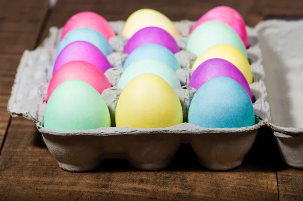 Egg carton of colorful dyed Easter eggs — Stock Photo, Image