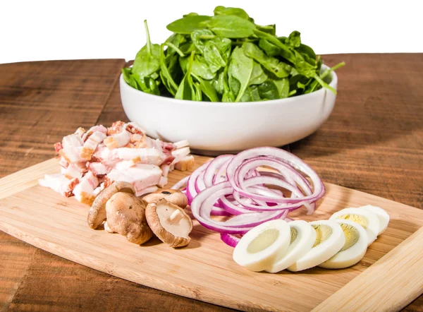 Bowl of green spinach with ingredients — Stock Photo, Image