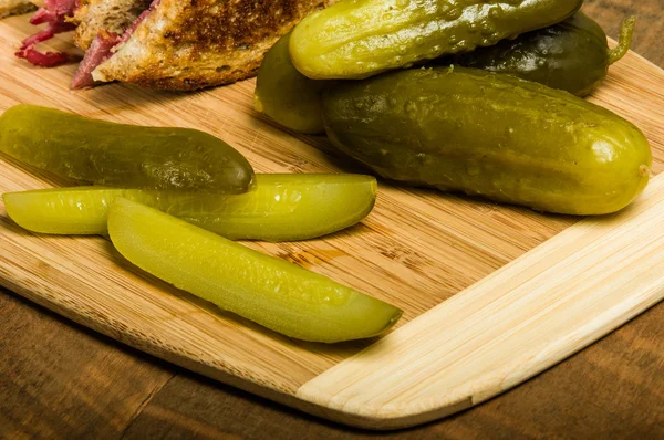 Reuben sandwich with dill pickles — Stock Photo, Image