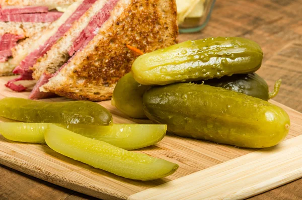 Reuben sandwich with dill pickles — Stock Photo, Image