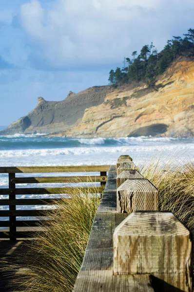 Row of fence posts leading into the ocean — Stock Photo, Image