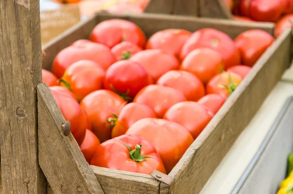 Wooden box display of red tomatoes — Stock Photo, Image