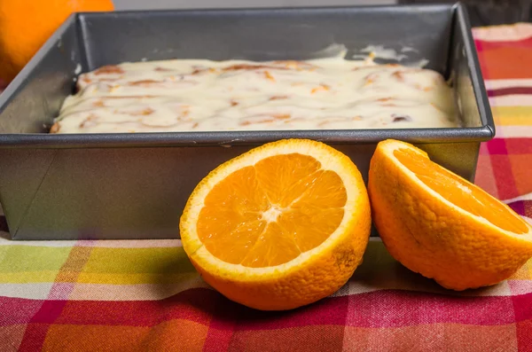 Oranges with fresh sweet rolls — Stock Photo, Image